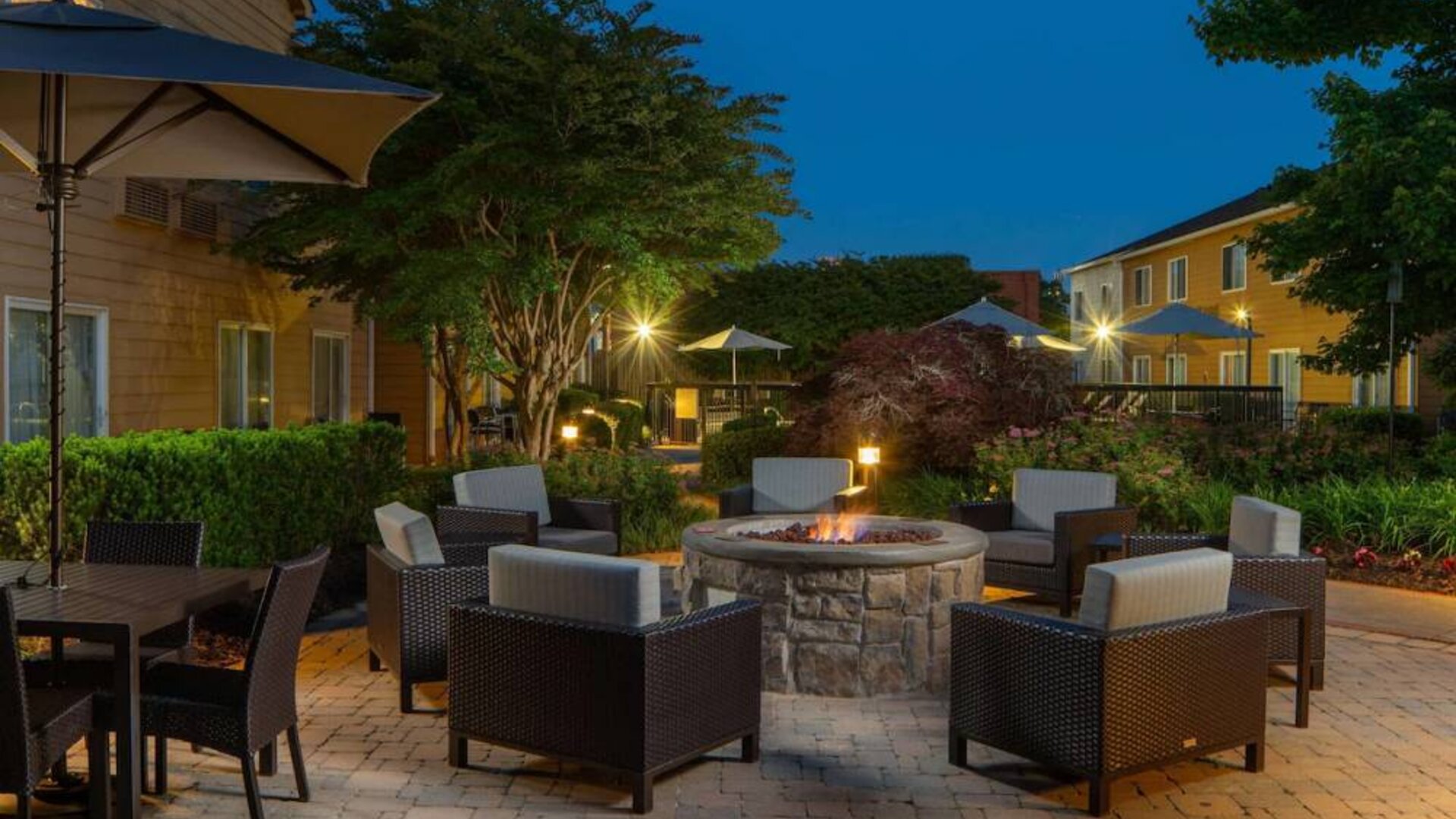 Sonesta Select Chattanooga Hamilton Place’s outdoor fire pit is ringed by armchairs and has pleasant greenery nearby.