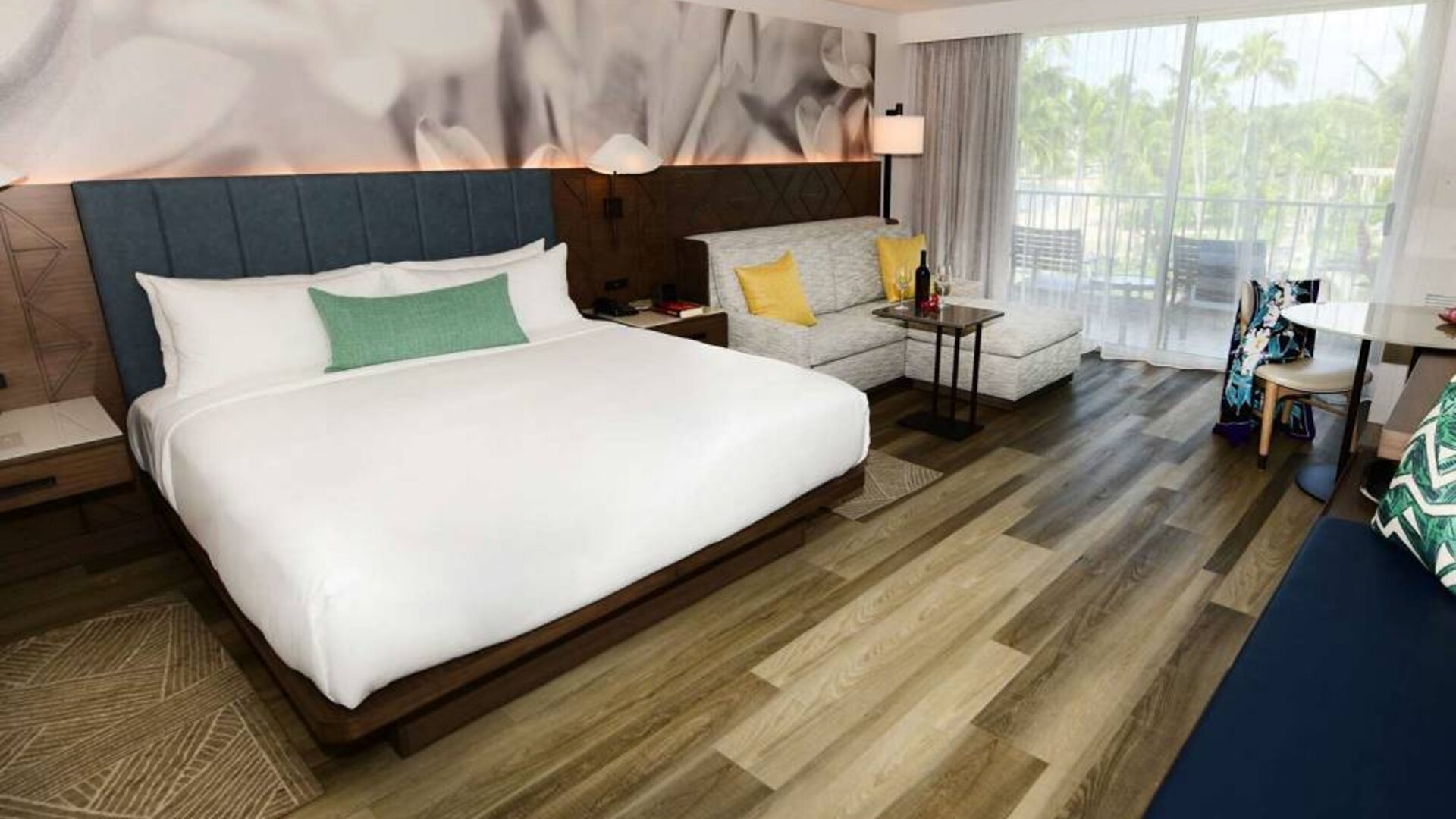 Double bed guest room in Royal Sonesta Kaua'i Resort Lihue, including corner sofa, coffee tables, and a balcony.