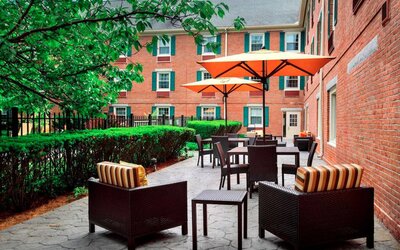 The hotel’s patio has armchairs and coffee tables, plus shaded tables and chairs.