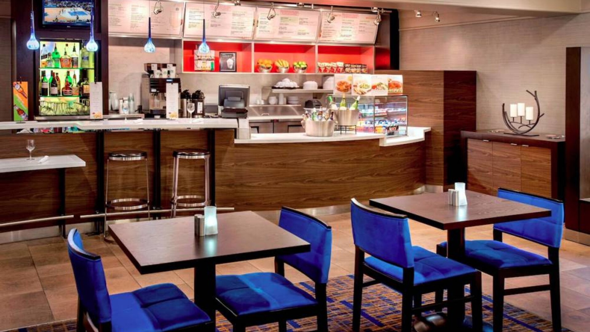 Breakfast area in Sonesta Select Boston Danvers, with seating at small tables or tall bar stools, and a range of healthy options.