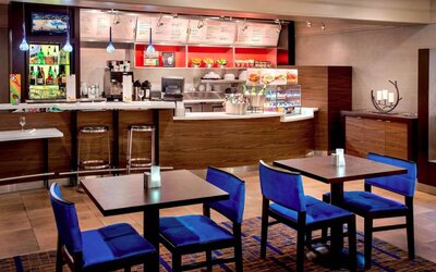 Breakfast area in Sonesta Select Boston Danvers, with seating at small tables or tall bar stools, and a range of healthy options.