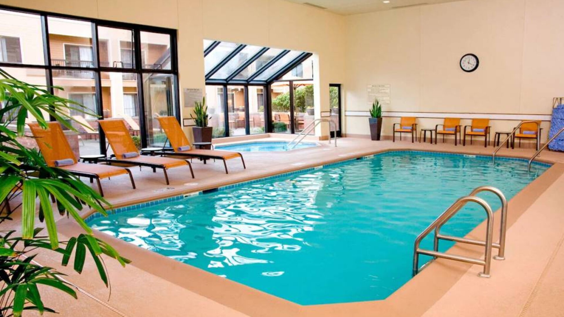 Sonesta Select Seattle Bellevue Redmond’s indoor pool has an adjacent hot tub and nearby loungers and chairs.