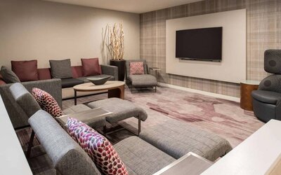 The lobby in Sonesta Select Seattle Bellevue Redmond features an enormous television, comfortable seating and coffee tables.