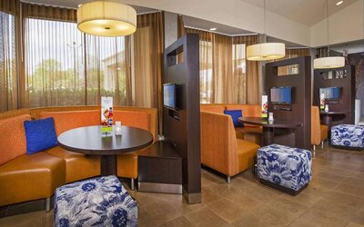 The hotel’s meeting pods provide comfortable seating with televisions and coffee tables for guests to socialize and work.