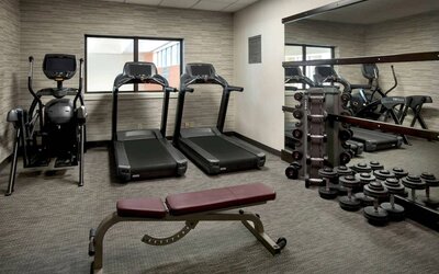 The hotel’s fitness center has treadmills, an elliptical machine, bench, and assorted free weights.