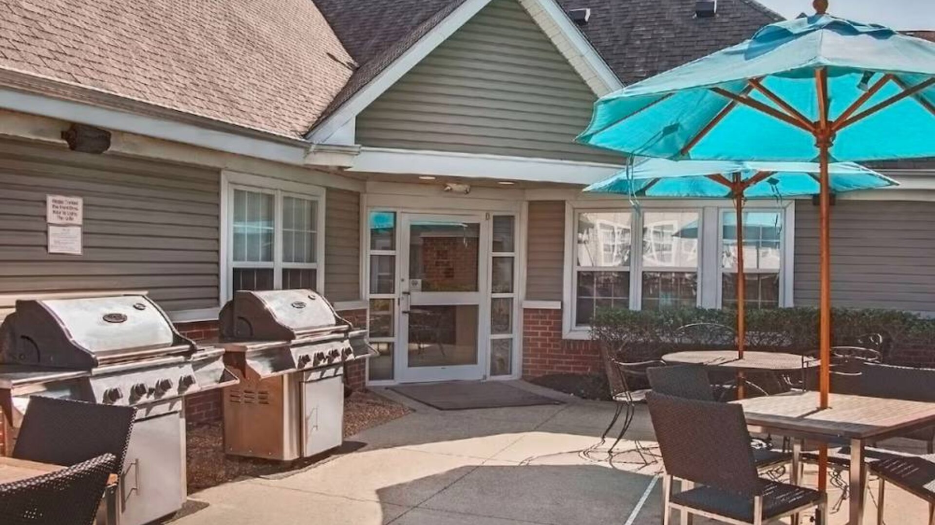 The hotel’s patio area includes shaded tables and chairs, as well as multiple barbecues.