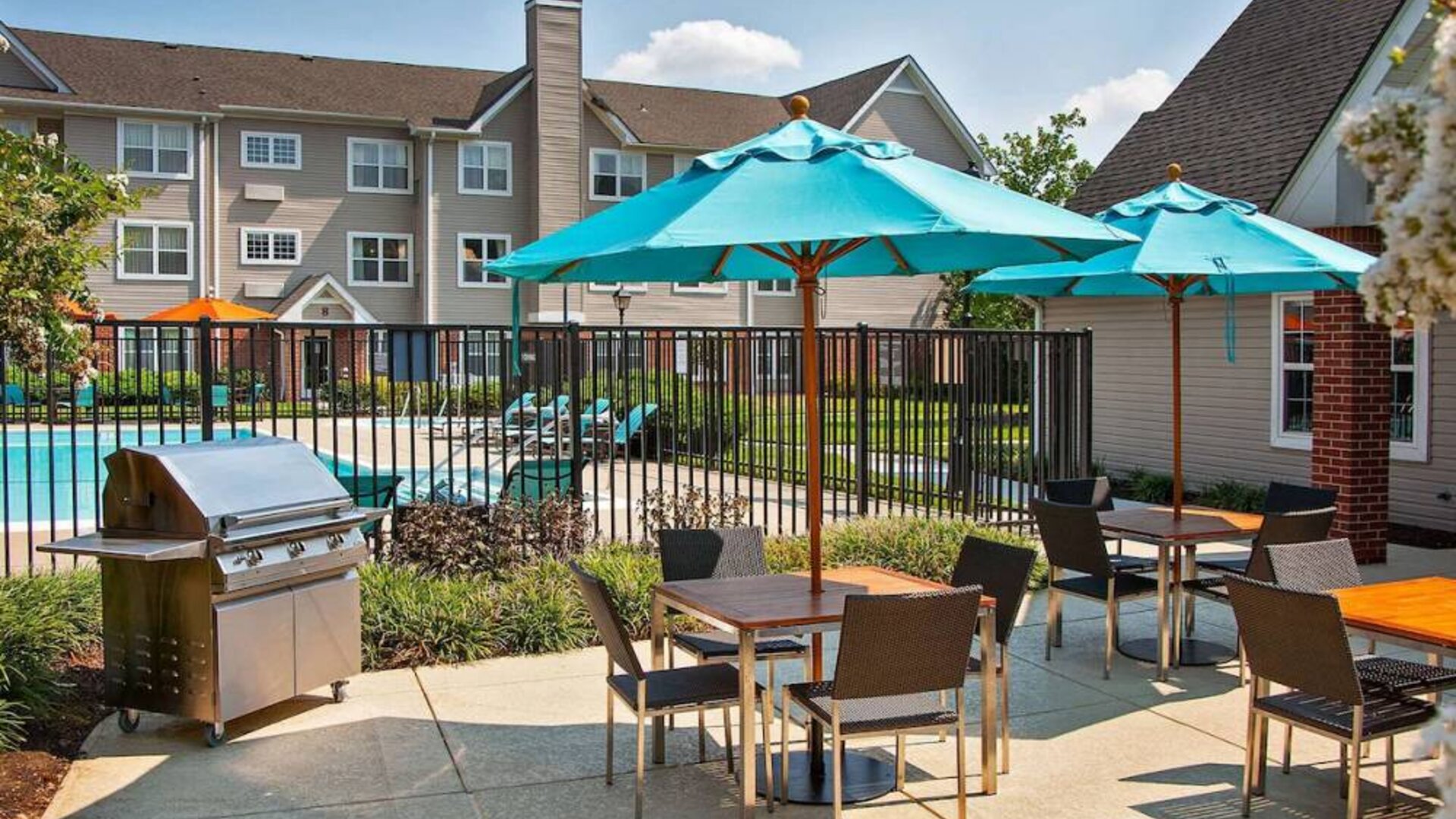 The hotel’s patio has shaded tables and chairs next to a barbecue, with the swimming pool only steps away.