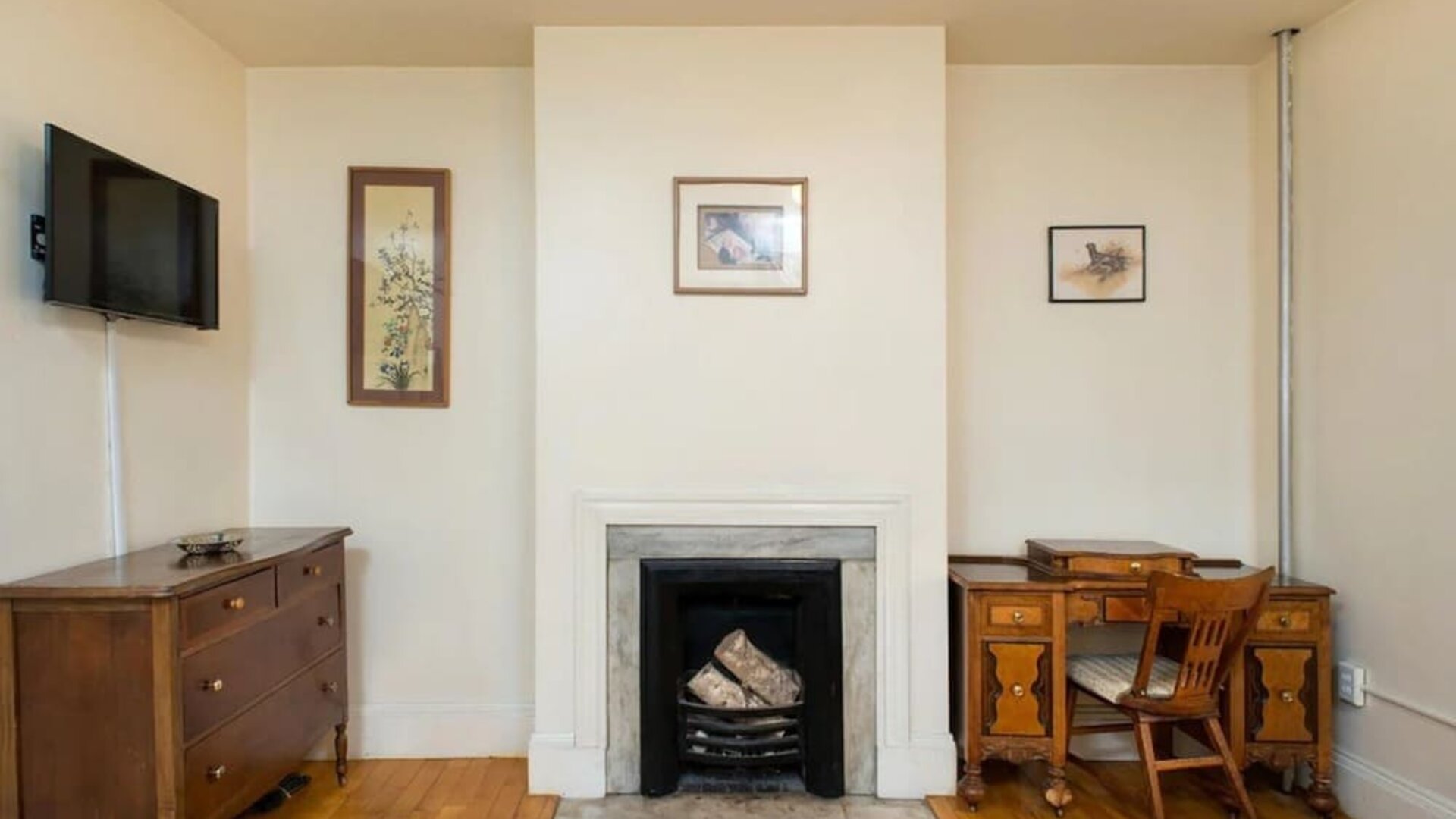 Day use room with TV, workspace, and chimney at The Farrington Inn.