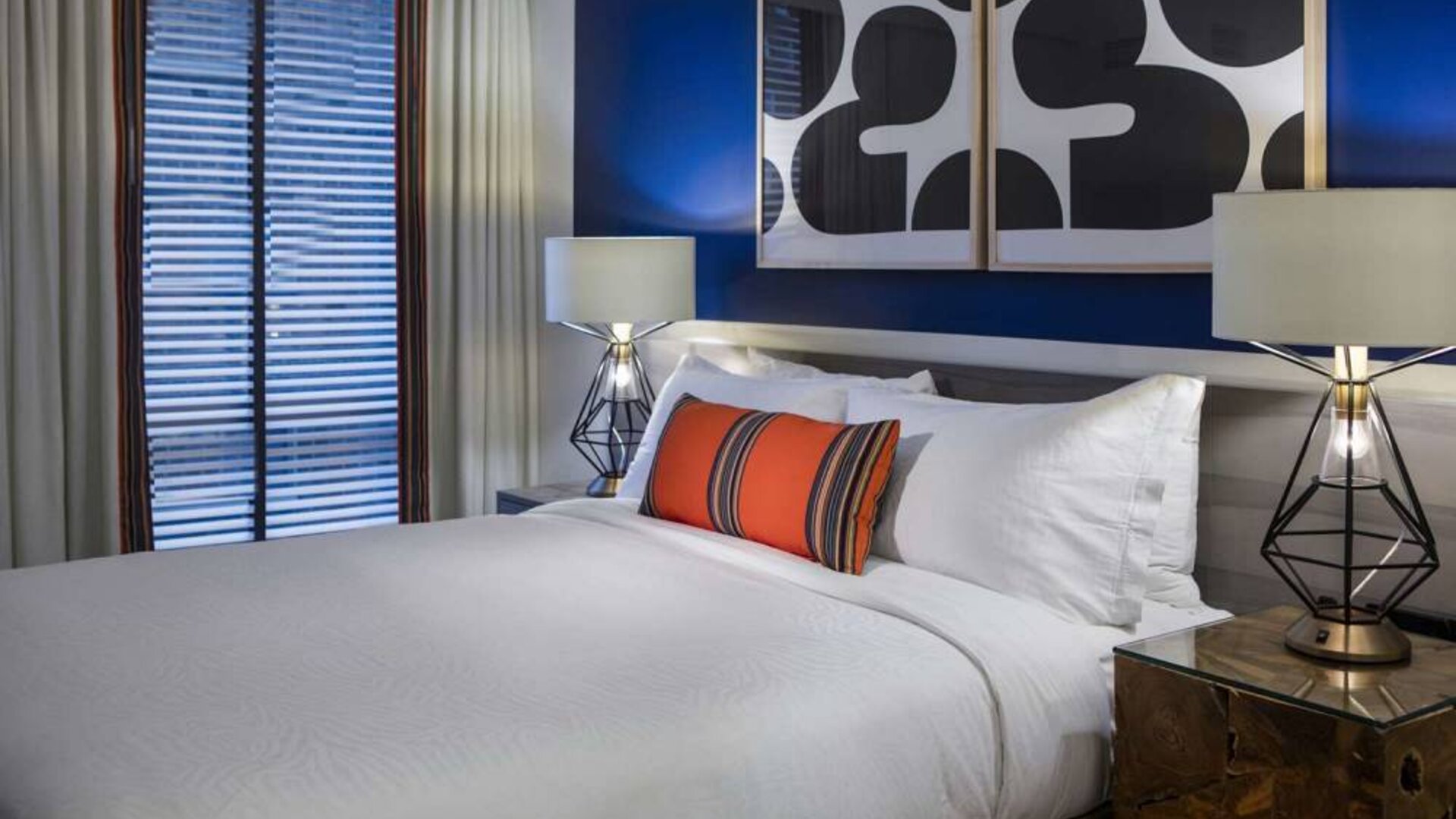 Royal Sonesta Washington DC Dupont Circle double bed guest room, featuring bedside lamps, art on the wall, and window.