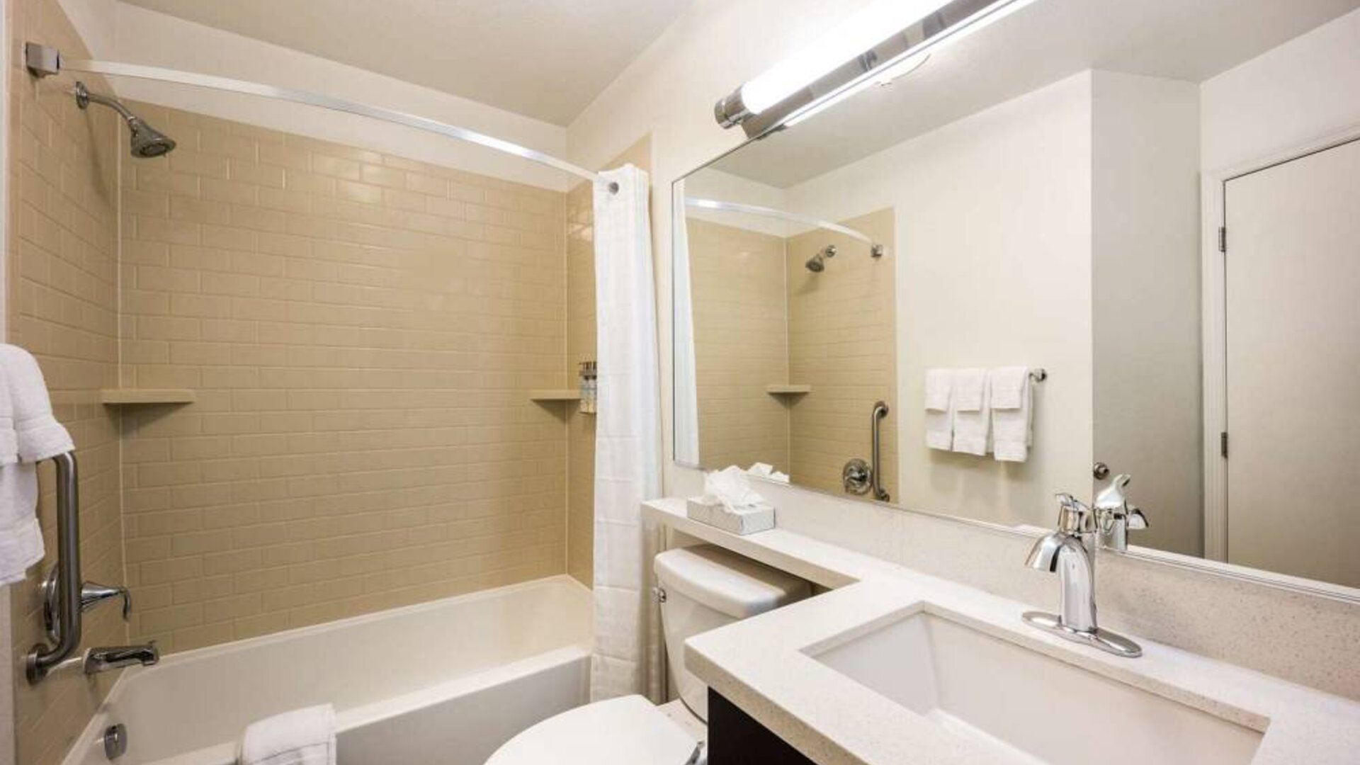 Guest bathroom in Sonesta Simply Suites Cleveland North Olmsted Airport, furnished with sink, lavatory, shower, and bath.