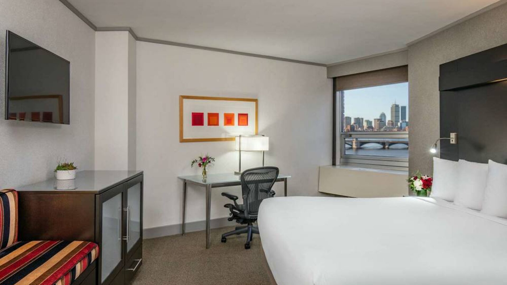 Royal Sonesta Boston double bed guest room, including workspace desk and chair, plus television.