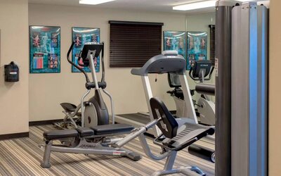 Sonesta Simply Suites Pittsburgh Airport’s fitness center is equipped with an assortment of exercise machines and a bench for those using weights.