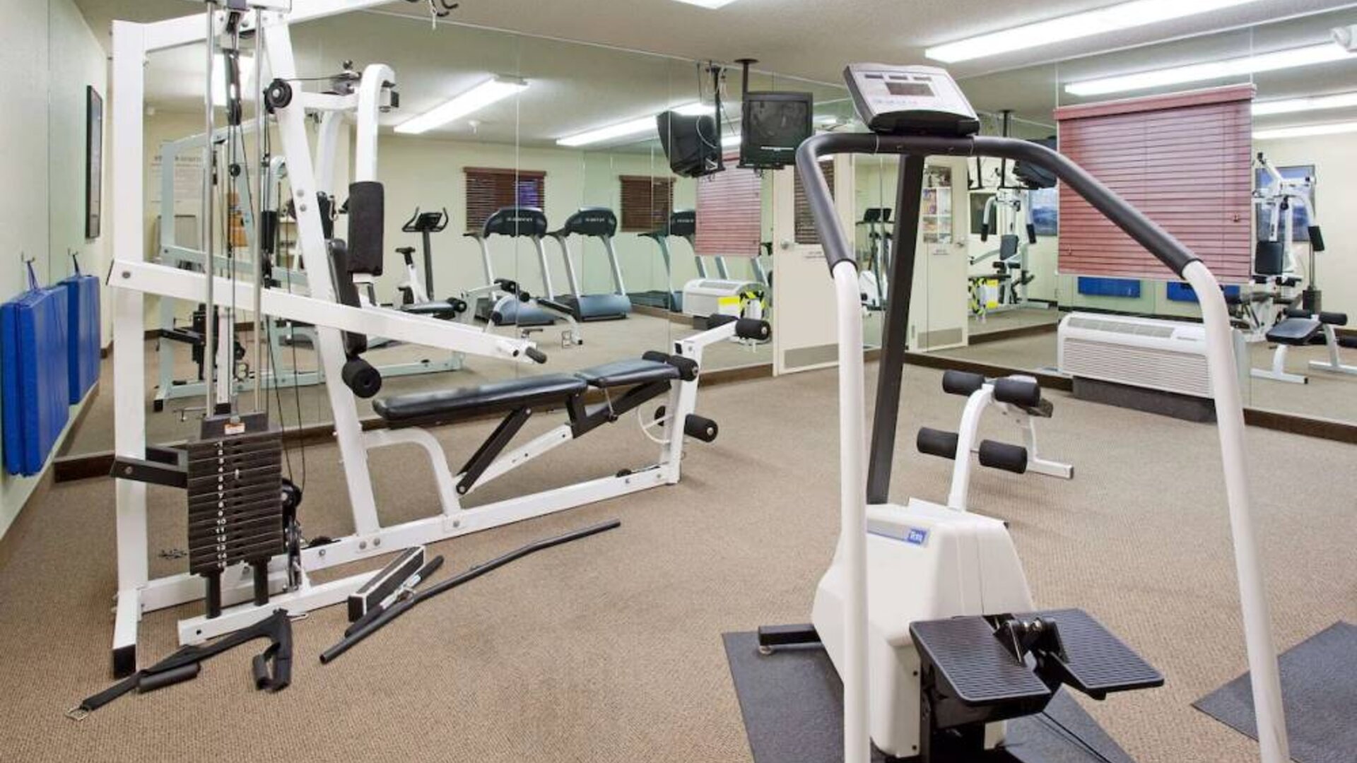 Sonesta Simply Suites Salt Lake City Airport’s fitness center has a diverse array of exercise machines and a television set.
