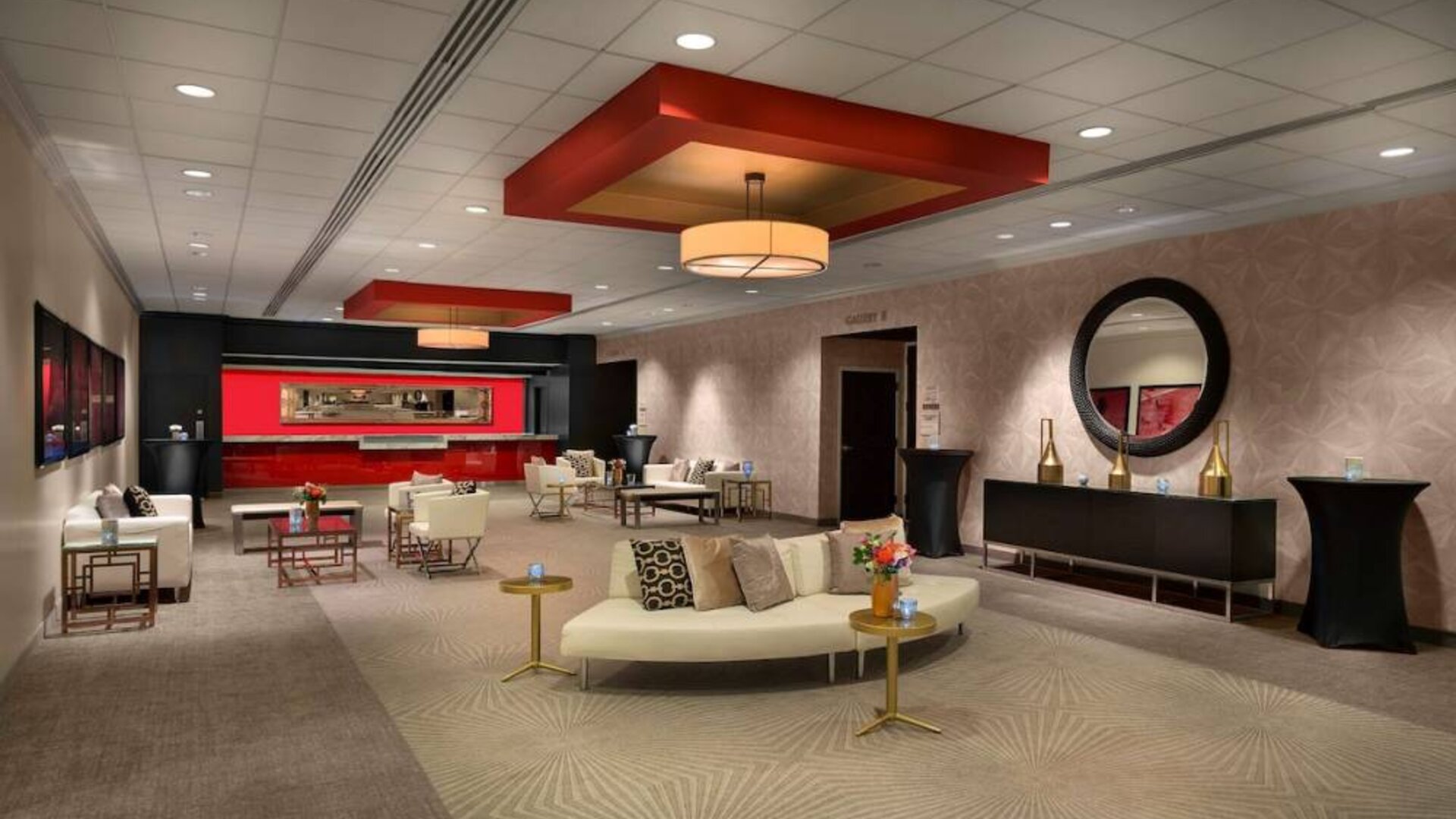 The lounge in Sonesta Philadelphia Rittenhouse Square’s lobby is furnished with sofas and comfy chairs, numerous coffee tables, and is a spacious setting.