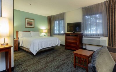 Double bed guest room in Sonesta ES Suites Anaheim Resort Area, including two windows, coffee table, and a television.