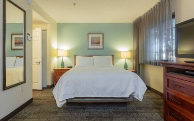 Sonesta ES Suites Anaheim Resort Area double bed guest room, featuring art on the wall, TV, and a window.