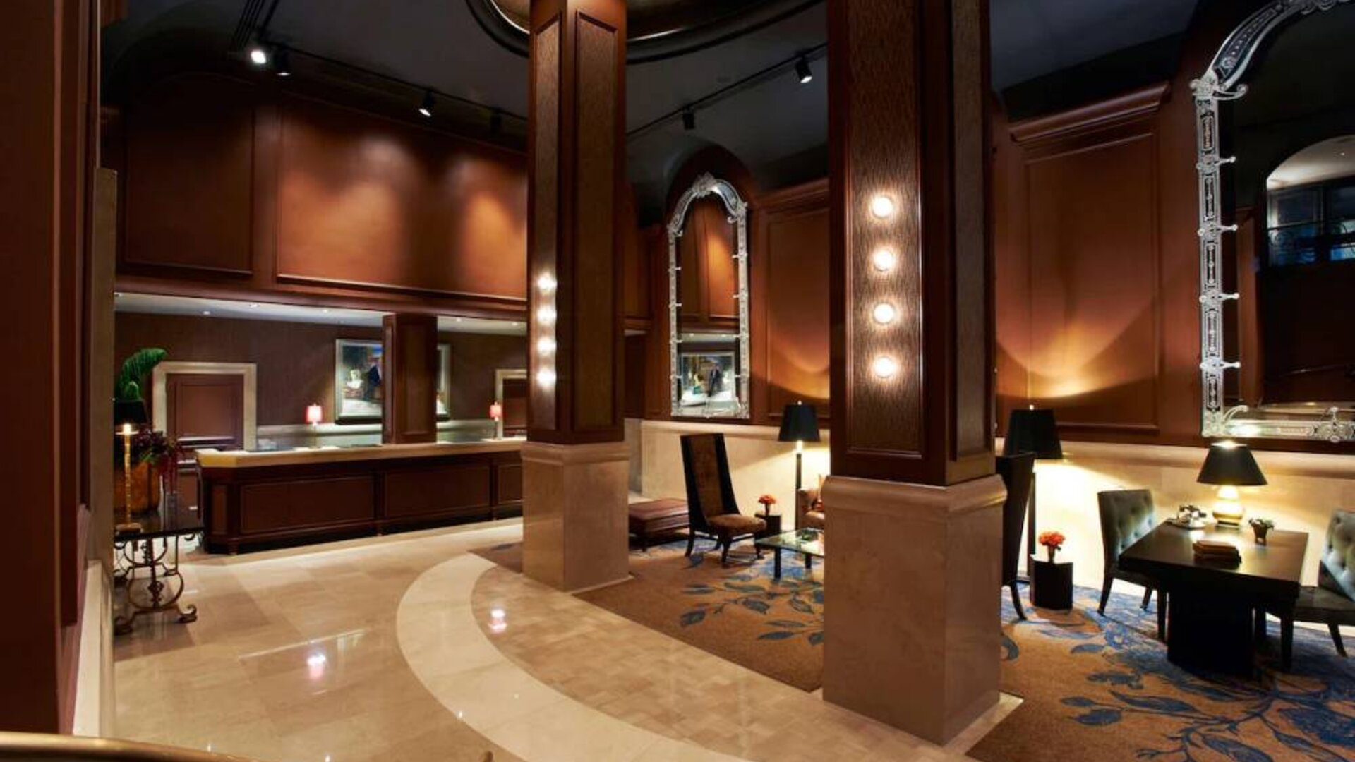 The Benjamin Royal Sonesta New York’s lobby includes coffee tables and chairs in a spacious environment.