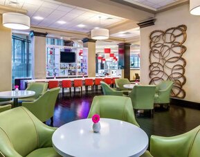 The hotel’s bar has a mix of bar stools and table seating, a hard floor, widescreen TV, and range of refreshing beverages.