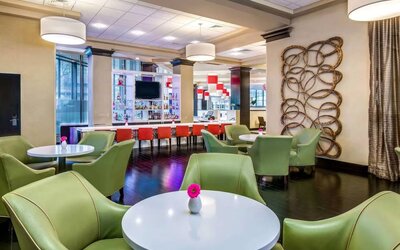 The hotel’s bar has a mix of bar stools and table seating, a hard floor, widescreen TV, and range of refreshing beverages.