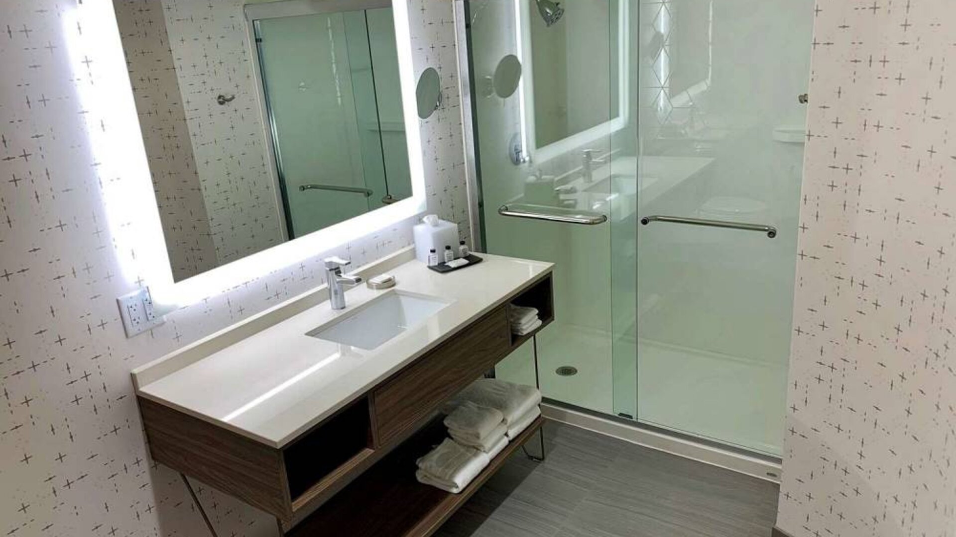 Guest bathroom in Sonesta Columbus Downtown, with shower, sink, and mirror.