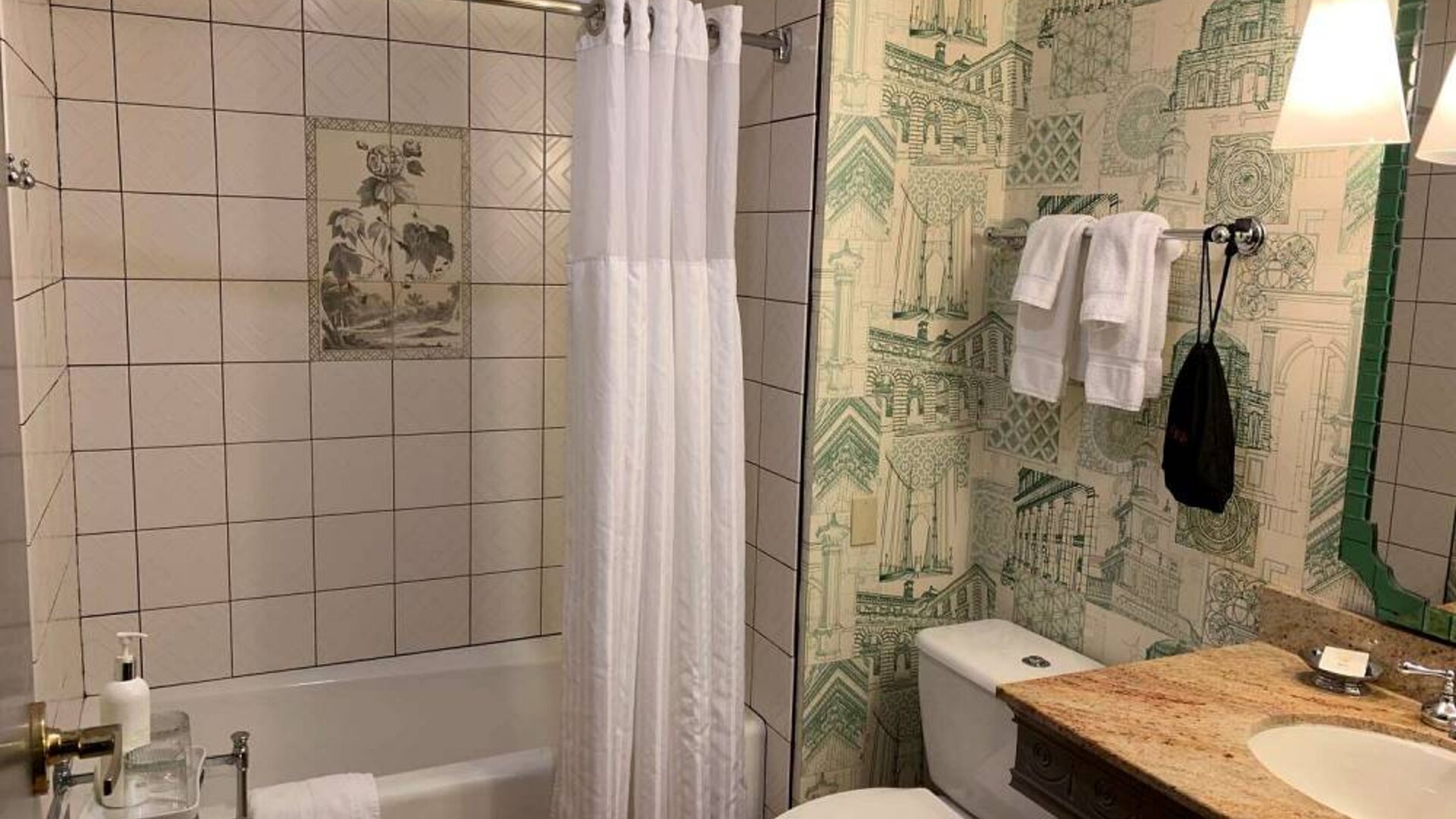 Guest bathroom in Royal Sonesta Portland Downtown, including sink, mirror, lavatory, and bath.