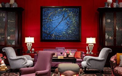 The lobby lounge in Royal Sonesta Portland Downtown is furnished with comfortable armchair and sofa seating, coffee tables, and art on the wall.