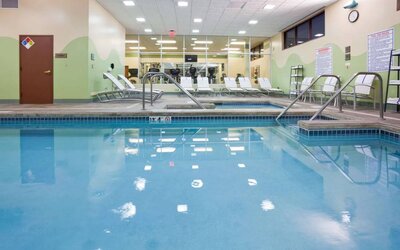 The indoor pool at Sonesta Milwaukee West Wauwatosa has an adjacent hot tub, sun loungers by the side, and is next to the fitness center.
