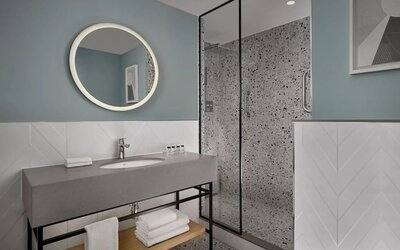 Guest bathroom with shower at Sheraton Amsterdam Airport Hotel And Conference Center.