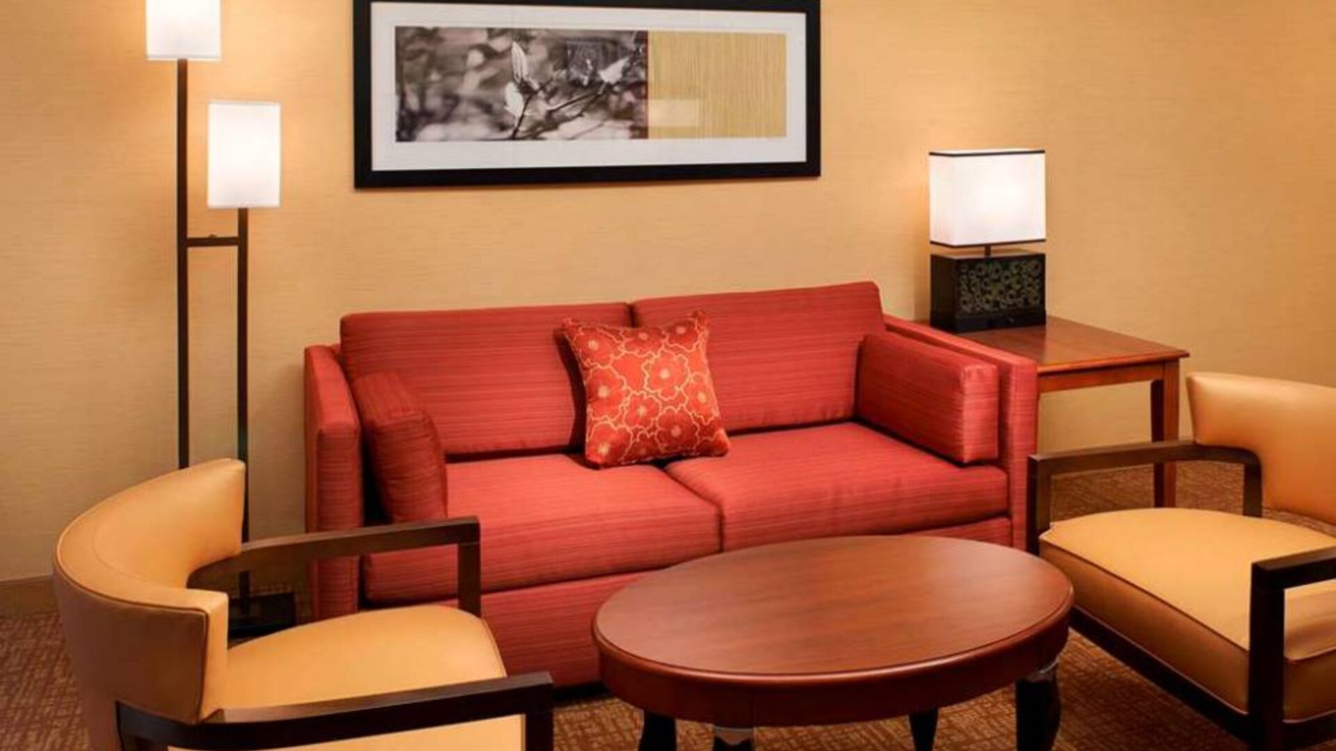 Sonesta Select Detroit Auburn Hills guest room living area, including two chairs, coffee tables, and a sofa.