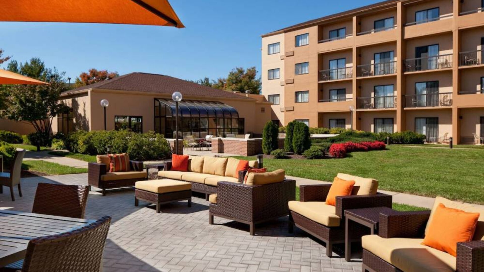 The hotel’s patio has armchairs and sofas, with coffee tables, as well as shaded tables and chairs.