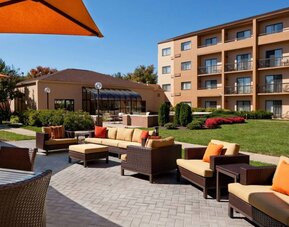 The hotel’s patio has armchairs and sofas, with coffee tables, as well as shaded tables and chairs.
