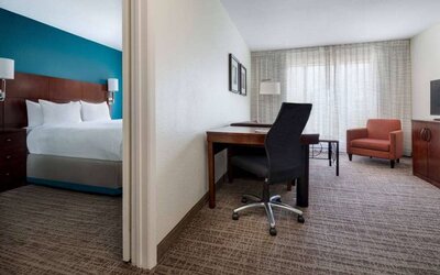 Sonesta ES Suites Dallas Medical Market Center double bed guest room, including a workspace desk and chair.