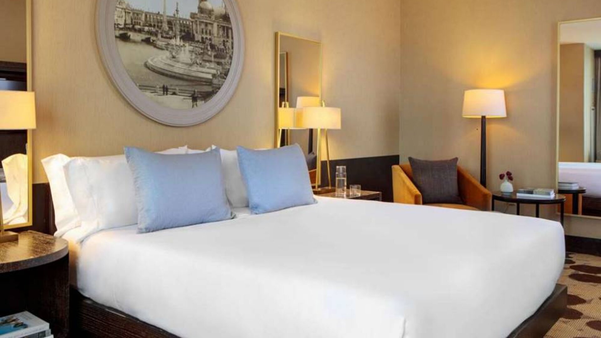 Royal Sonesta Chicago River North double bed guest room, furnished with bedside lamps, coffee table, and an armchair.