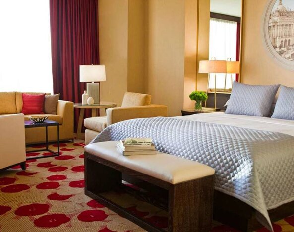 Royal Sonesta Chicago River North double bed guest room featuring chairs, coffee table, window, and a sofa.