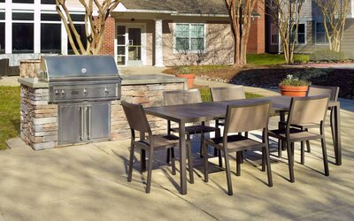 Barbecue with table and six chairs nearby at Sonesta ES Suites Raleigh Durham Airport Morrisville.