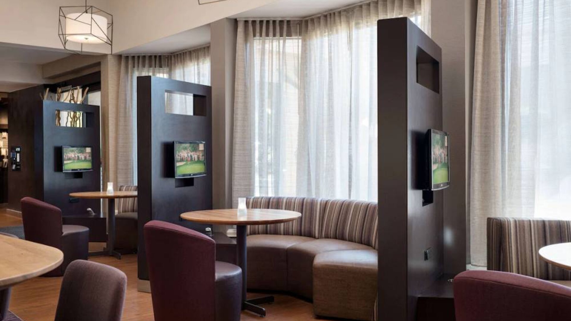 The hotel’s media pods are each furnished with a coffee table, TV, and comfortable seating.