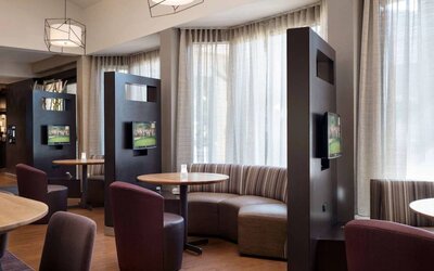 The hotel’s media pods are each furnished with a coffee table, TV, and comfortable seating.