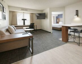 Double bed guest room living area in Sonesta ES Suites Fort Worth Fossil Creek, including sofa, window, and wall-mounted TV.