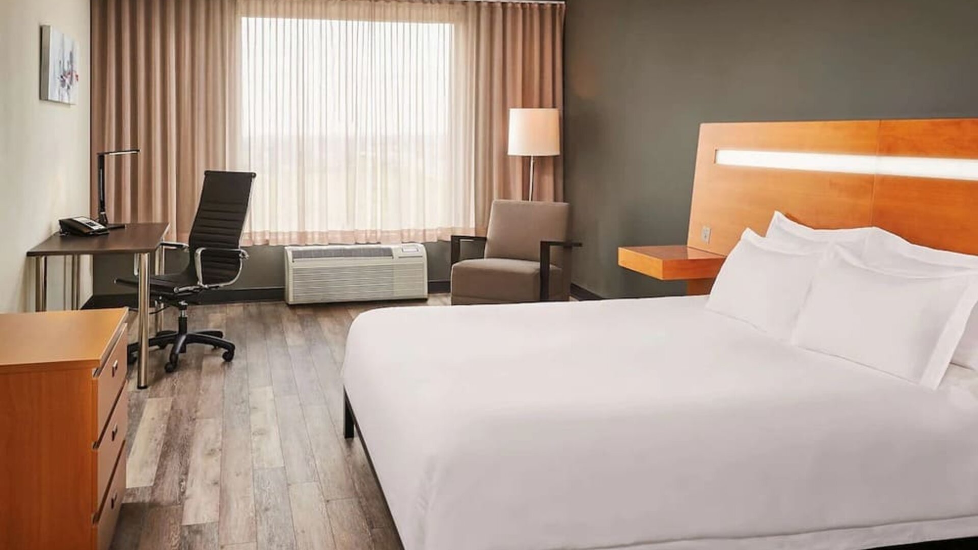 King bed with work desk at Novotel Toronto Vaughan Centre.