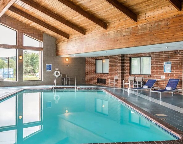 Indoor pool with pool loungers at EnVision Hotel St. Paul South.