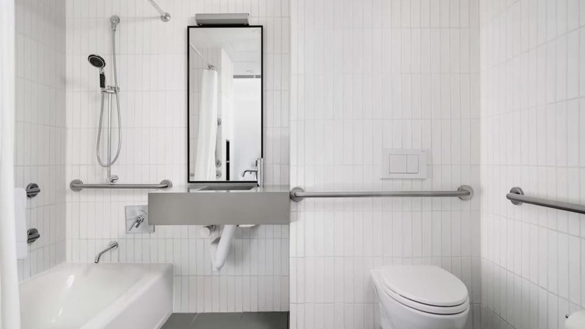Guest bathroom with shower and bath at Arlo SoHo.
