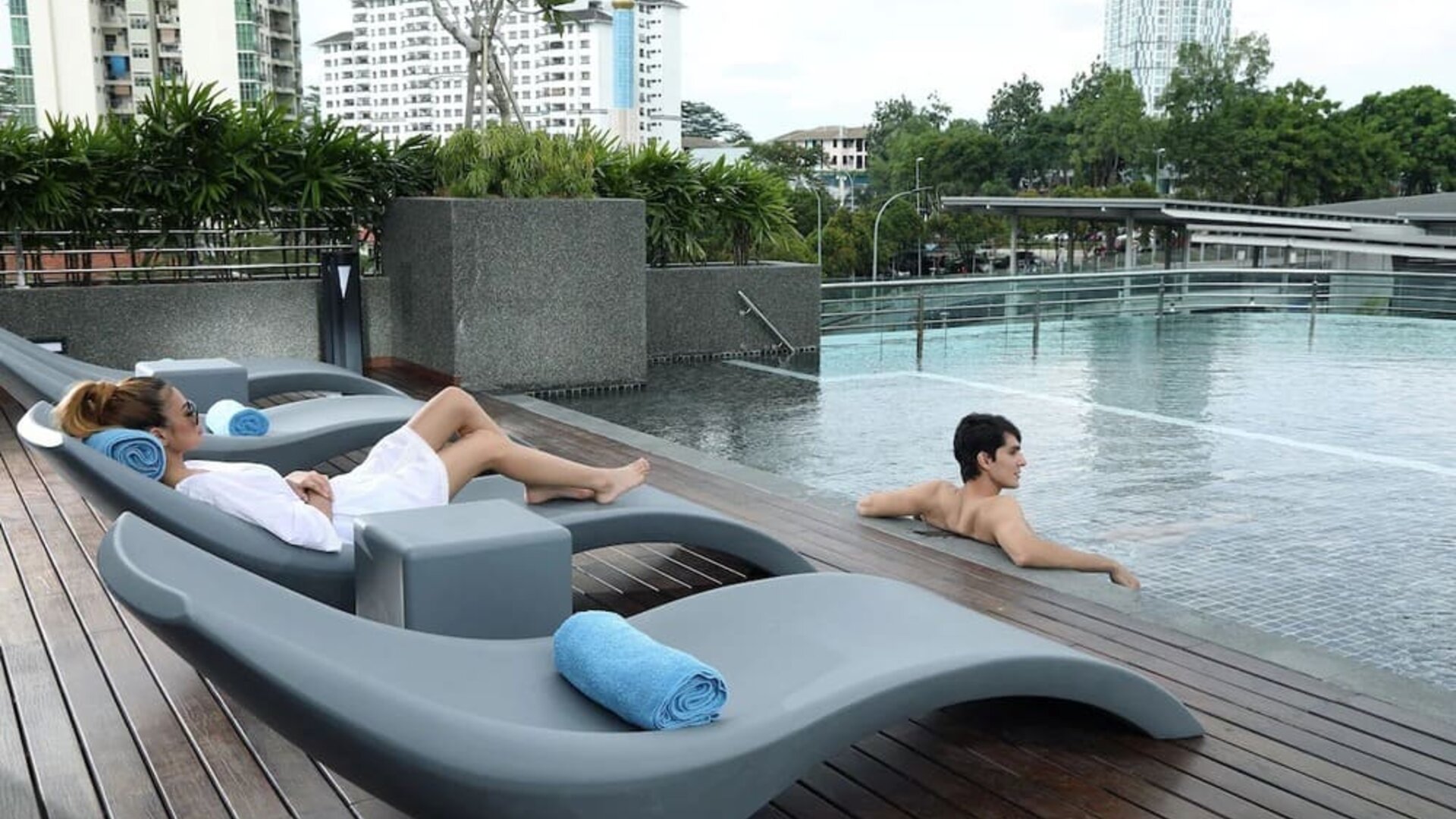 Stunning outdoor pool with lounge chairs at Capri By Fraser Johor Bahru.