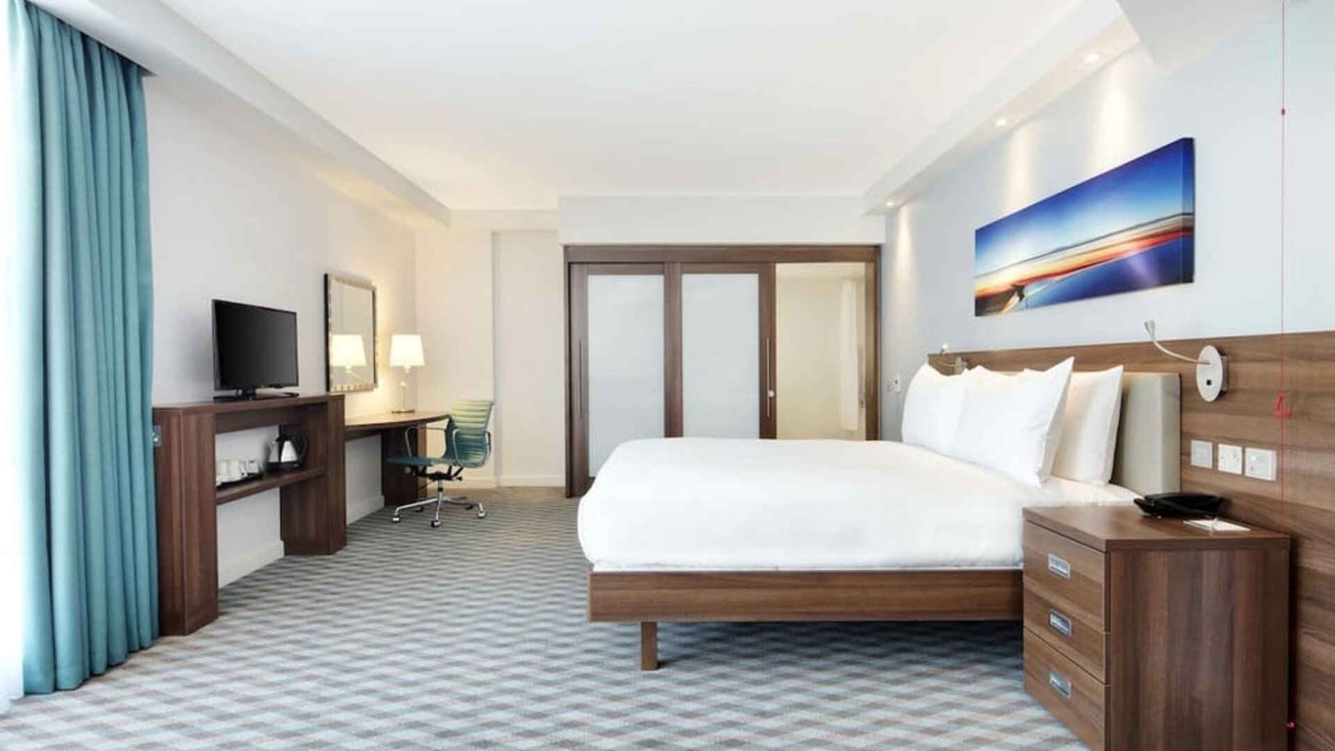 Spacious king room with TV at Hampton By Hilton London Stansted Airport.