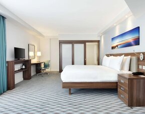 Spacious king room with TV at Hampton By Hilton London Stansted Airport.