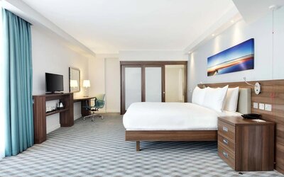 Spacious king room with TV at Hampton By Hilton London Stansted Airport.