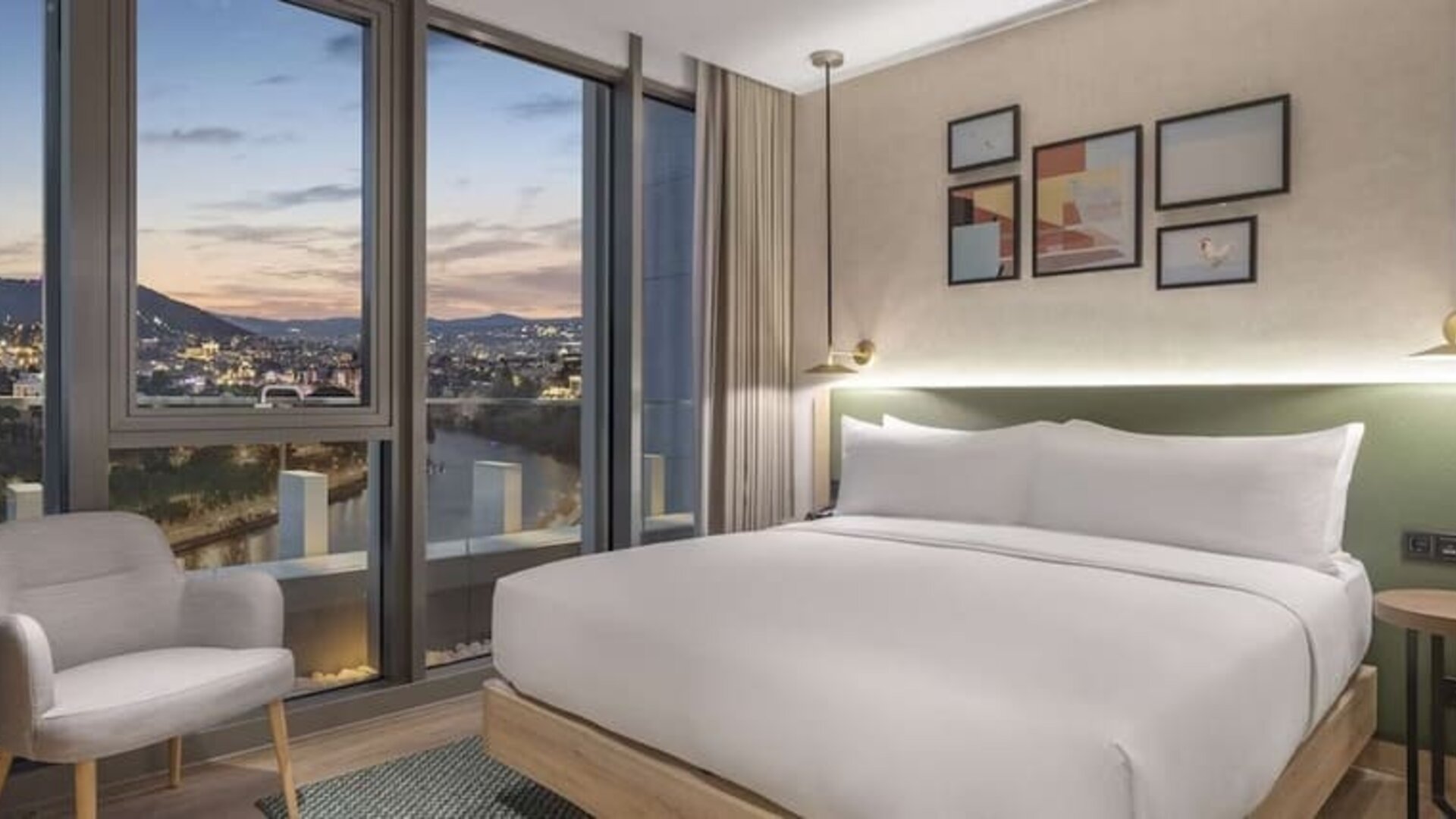 Delux king room with chair at Hilton Garden Inn Tbilisi Riverview.