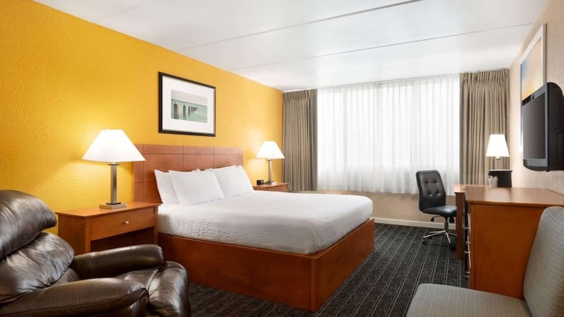 Spacious king room with work desk at EnVision Hotel Miami International Airport.