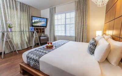 King room with TV and work space at Chesterfield Hotel & Suites.