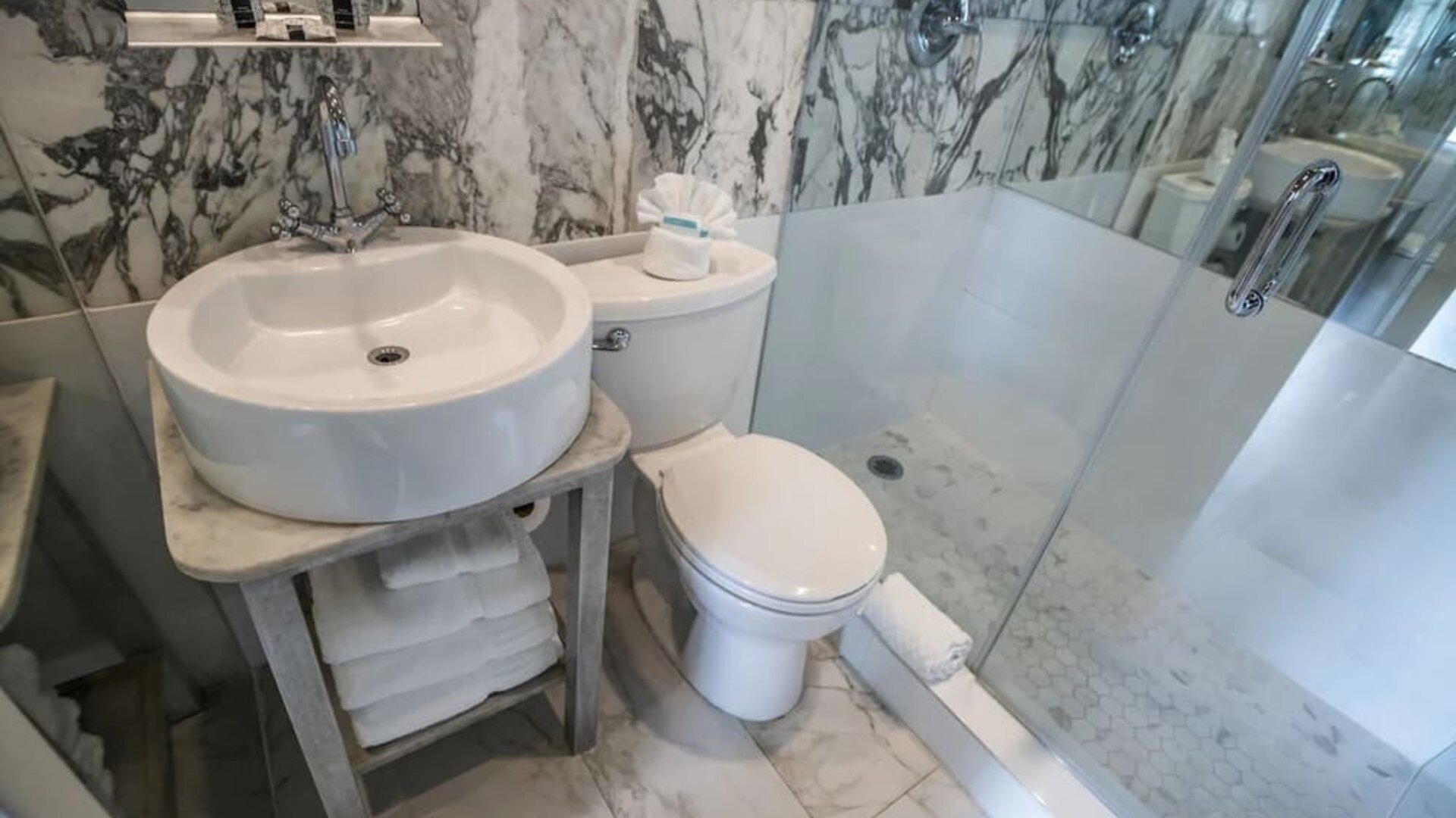 Guest bathroom with shower at Chesterfield Hotel & Suites.
