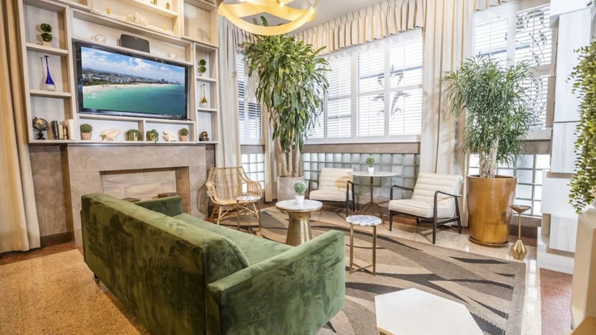 Lobby and lounge area with TV at Chesterfield Hotel & Suites.